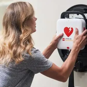 LifePak CR2 Defibrillator being pulled off the wall holder