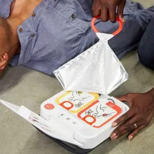Wrapper being pulled open on the portable defibrillator
