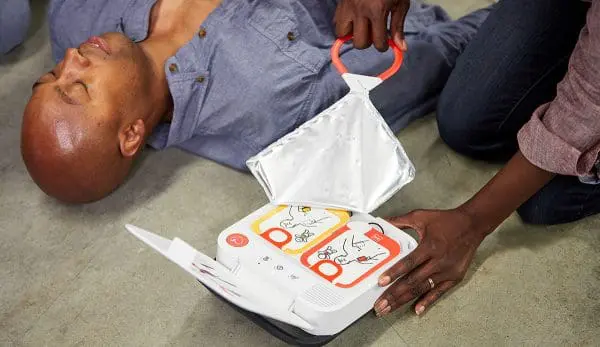 Wrapper being pulled open on the portable defibrillator