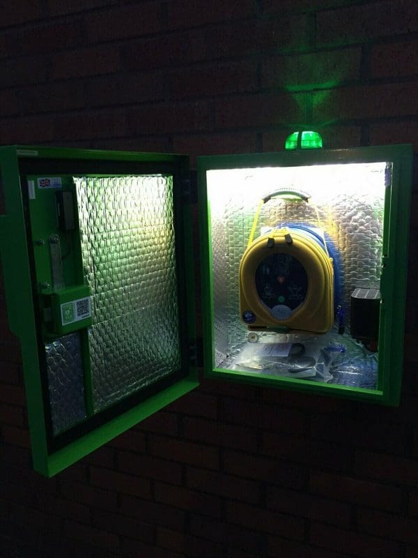 HeartSafe Cabinet with a defibrillator hanging on a hook
