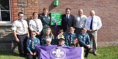 Children and adults posing with AED Defibrillator