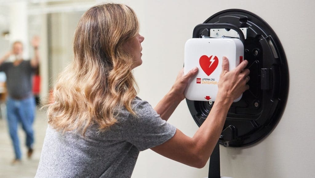 LifePak CR2 Defibrillator being pulled off the wall holder