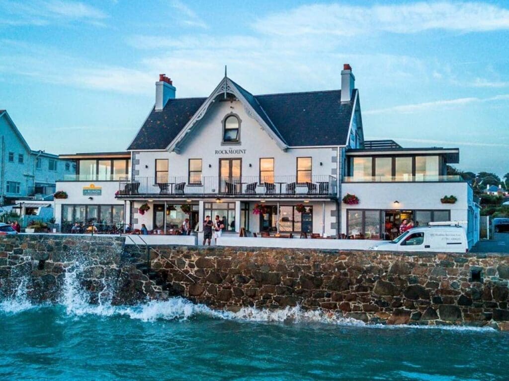 The Rockmount Pub in Guernsey, waves crashing against coast wall