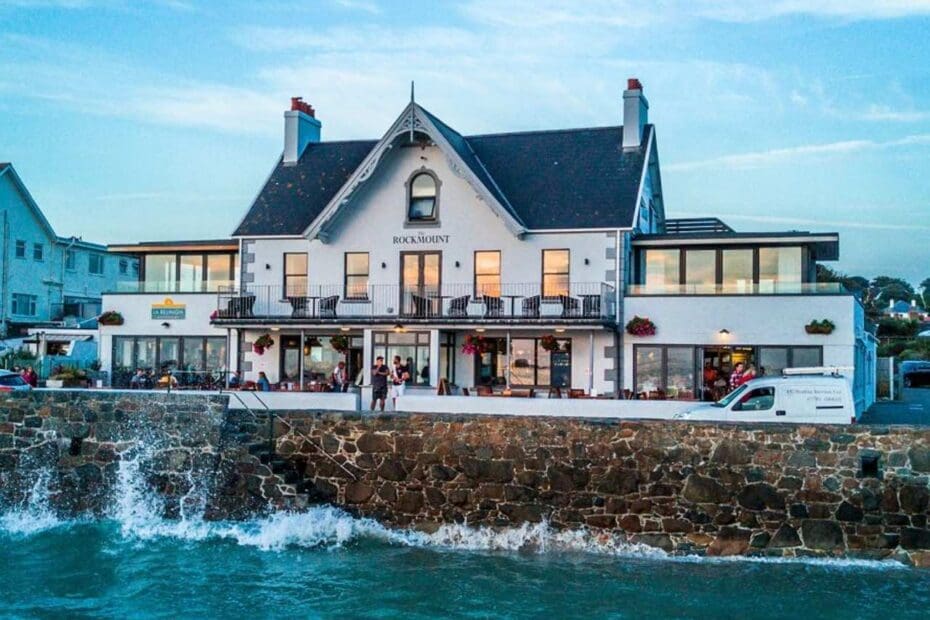 The Rockmount Pub in Guernsey, waves crashing against coast wall
