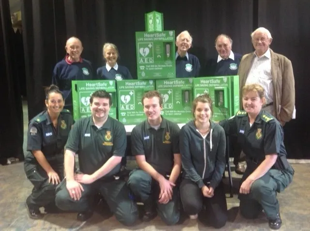 Group of Paramedics With External Defibrillator Cabinets